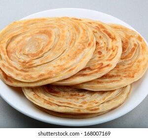 Tandoori Paratha Crispy whole wheat layered bread prepared in Traditional Clay Oven